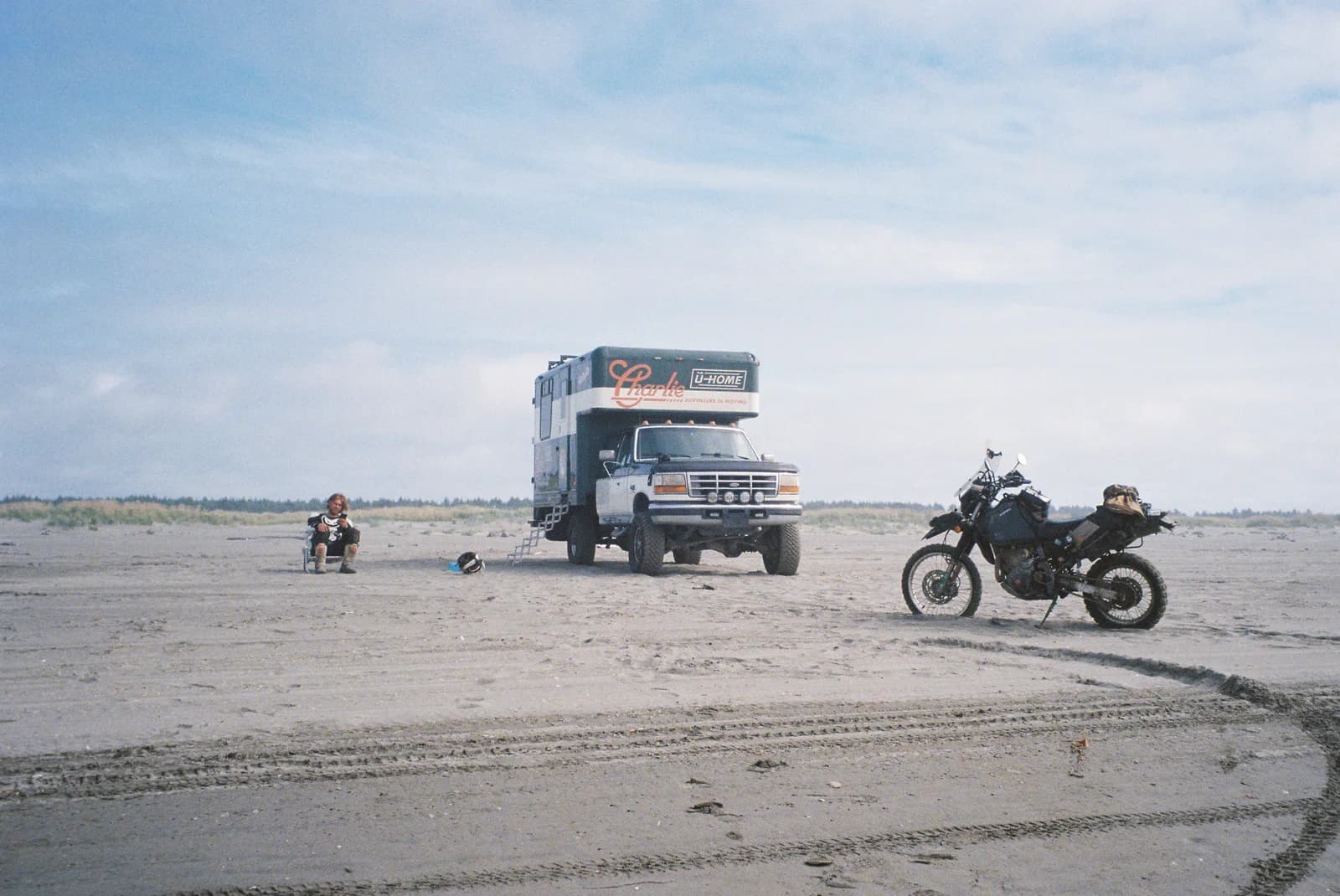 Charlie and a motorcycle parked on a beach