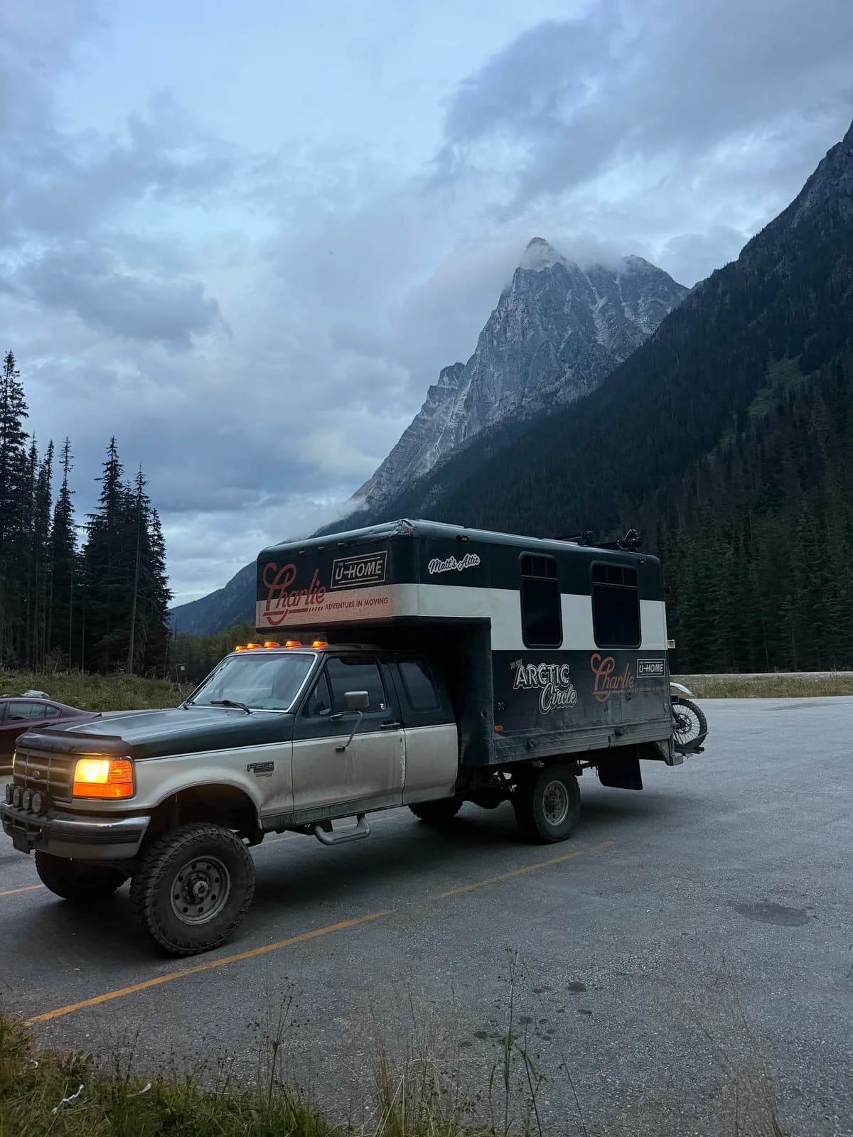 Charlie parked beneath steep mountain peaks