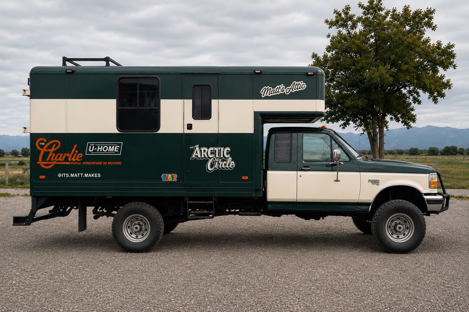 Charlie in profile — the finished green-and-white house truck, lettered with THE U-HOME and ARCTIC CIRCLE