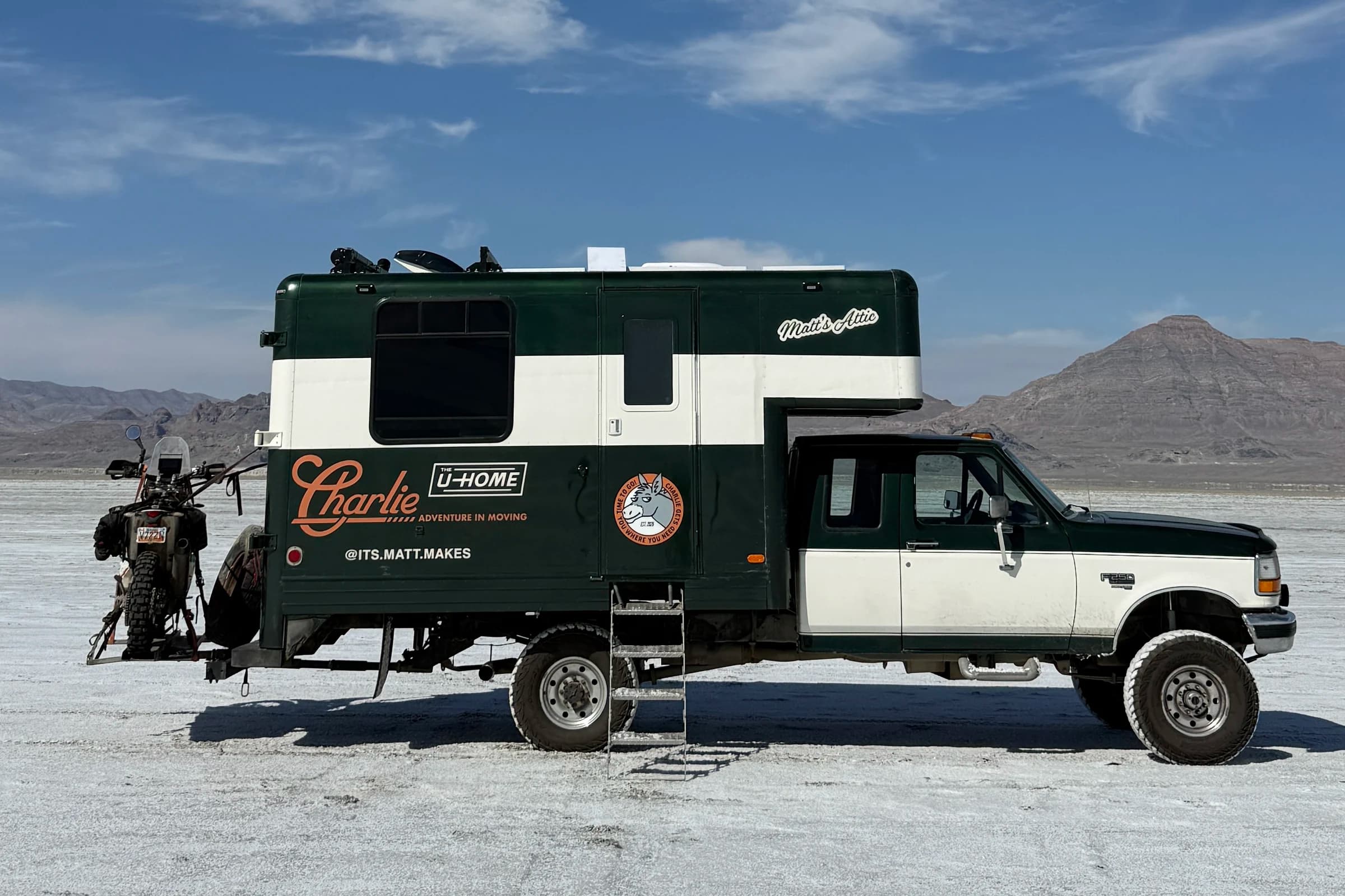 Charlie in profile, the finished green-and-white house truck lettered with THE U-HOME and ARCTIC CIRCLE